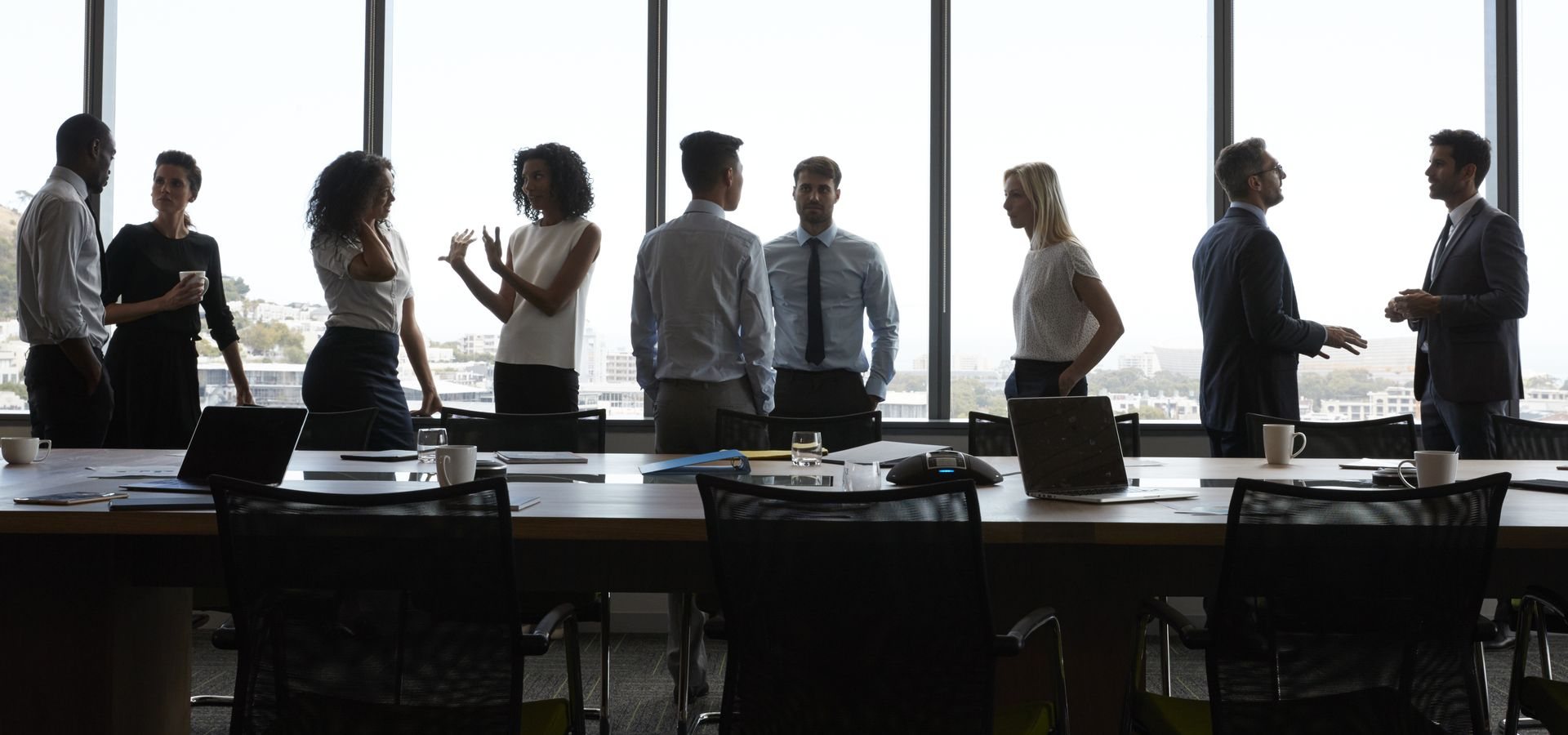 Team of professionals in silhouette at a conference table