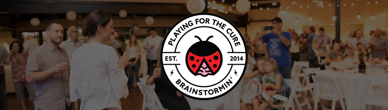 Playing for the Cure — Brainstormin' event banner over a crowd at the Connecticut fundraiser
