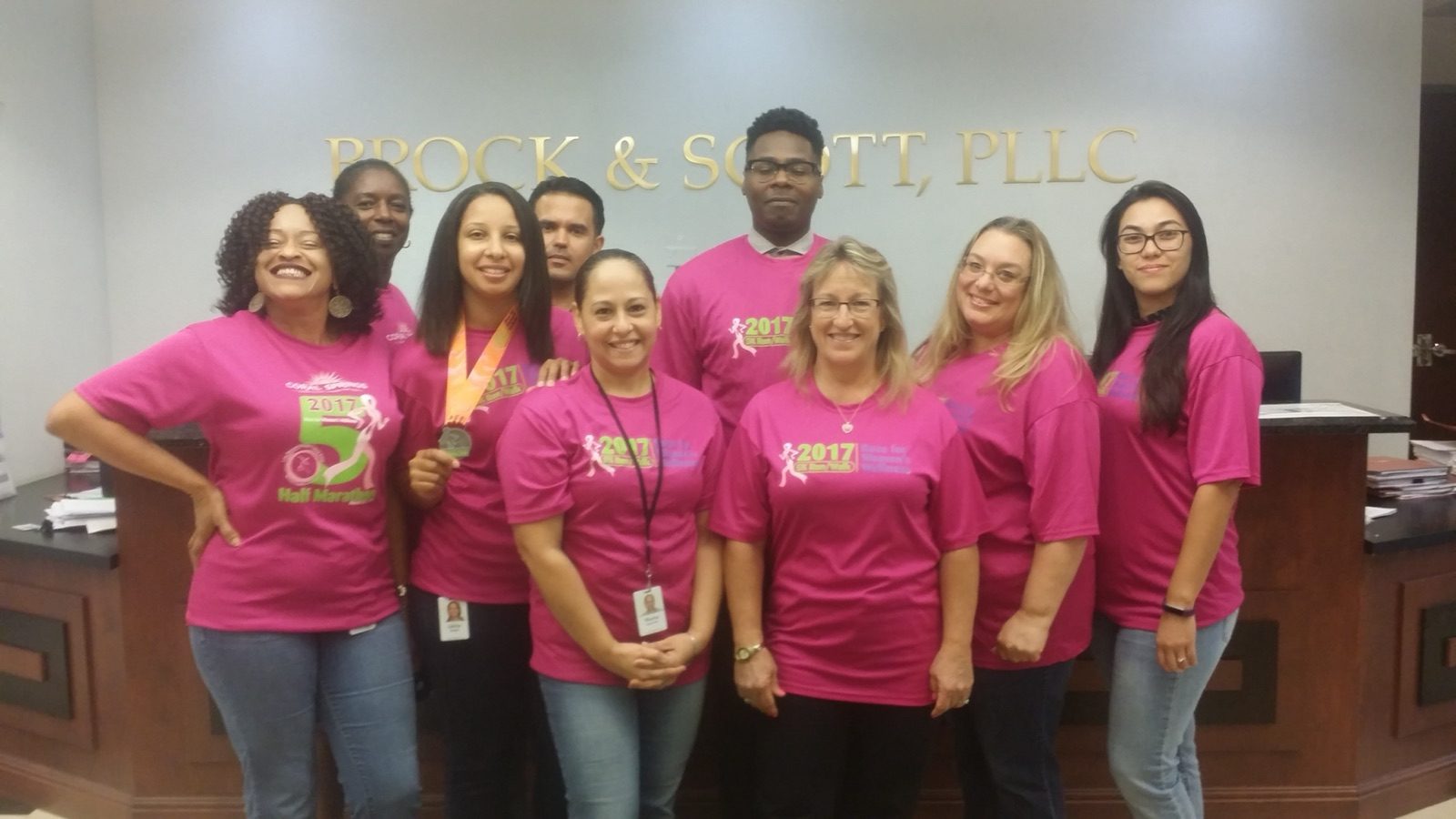 The Ft. Lauderdale team wearing 2017 Race for Women's Wellness shirts in the office